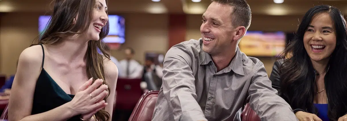 Players smiling and enjoying a live poker game at California Grand Casino